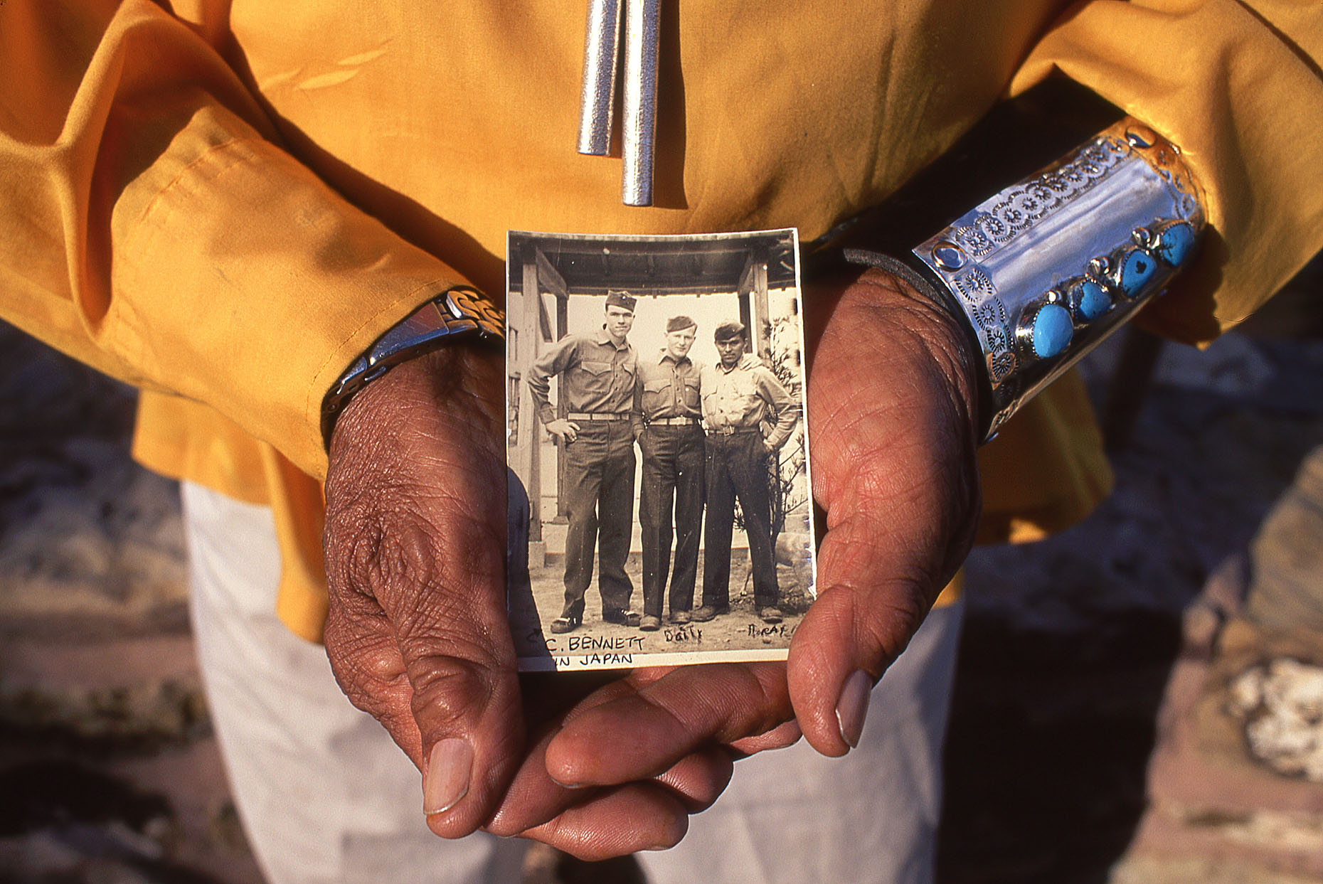 Navajo Code Talker Teddy Draper, Sr. John Annerino, Native American traditions, holds a World War II photo of himself and two buddies taken in Japan